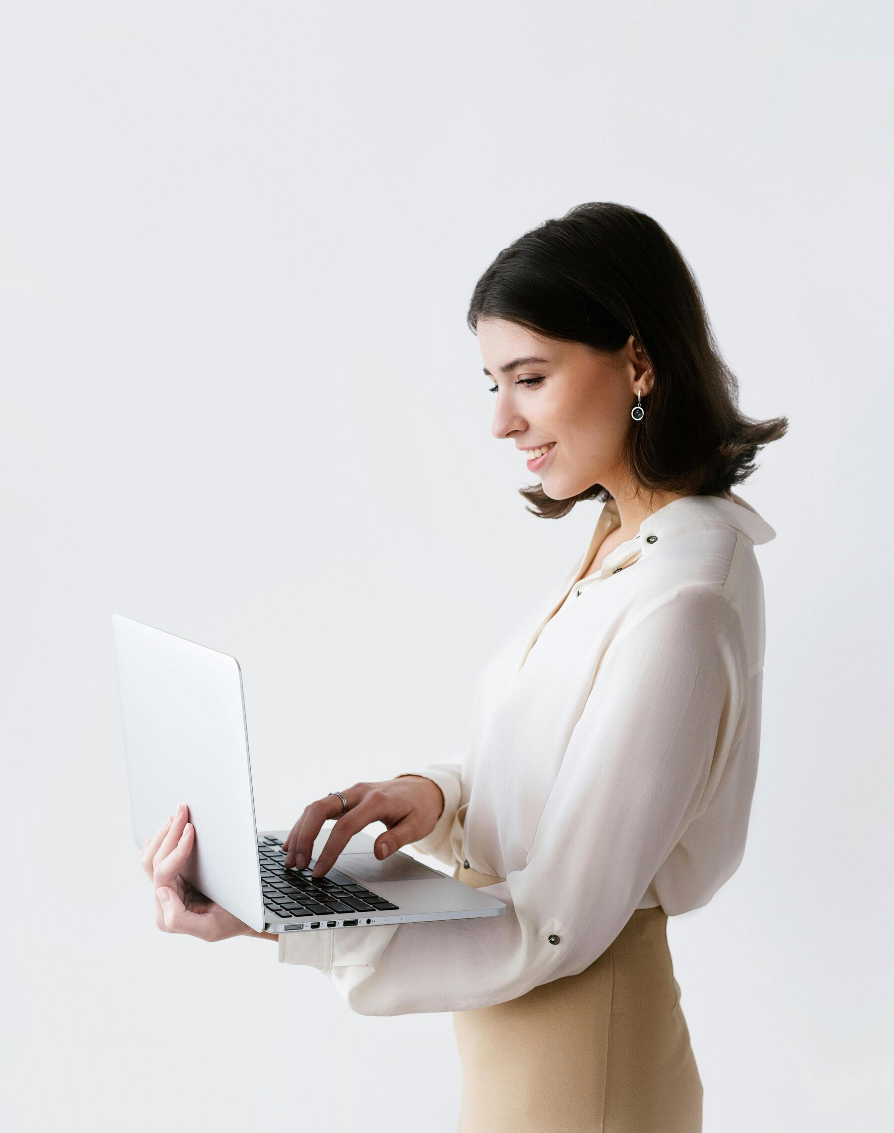 Smiling professional woman using a laptop, representing remote HR support services in the UK