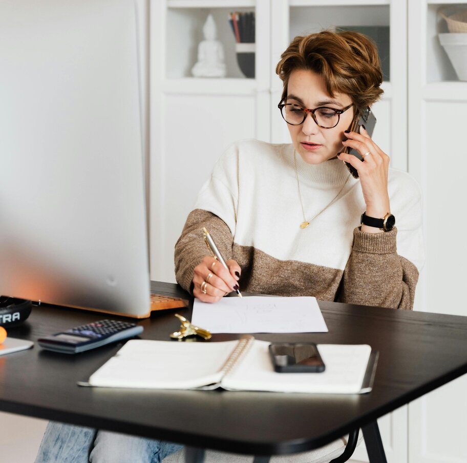 Professional woman providing remote HR support over the phone for a UK business